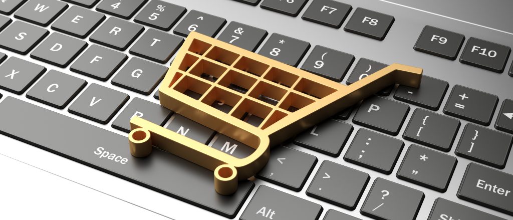 Shopping cart trolley icon on a computer laptop keyboard.