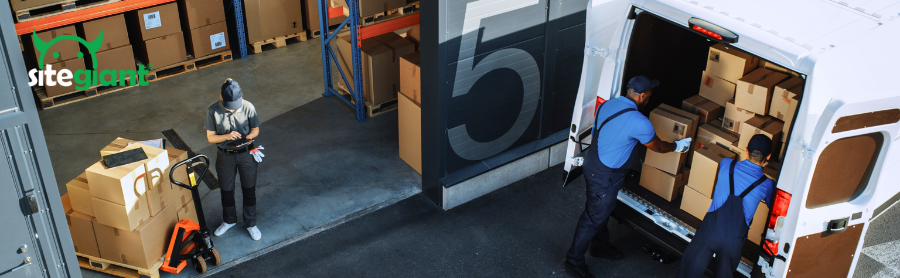 two men arranging boxes at the back of the van