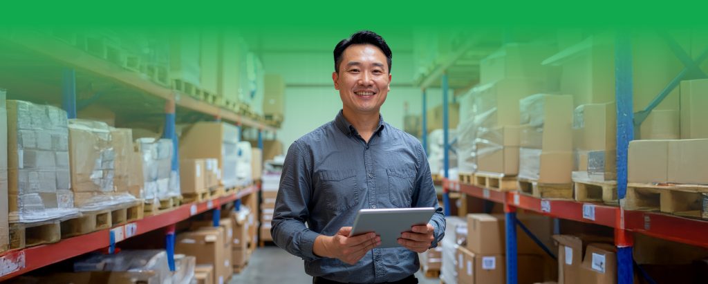 Filipino shop owner checking stock in a small warehouse with boxes neatly arranged – SiteGiant inventory management Philippine